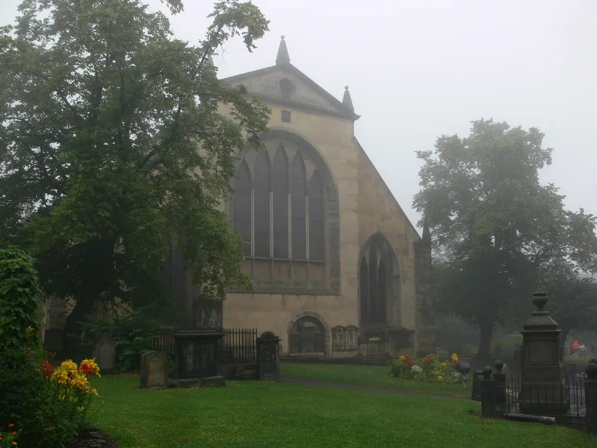 Greyfriars Kirk and its kirkyard lawn on a misty day, Edinburgh ghost tours, Edinburgh, Scotland
